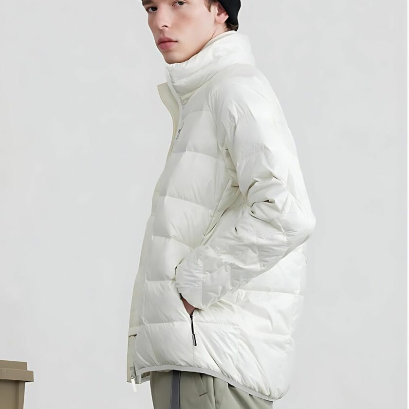 Weiße Wanderdaunenjacke für Männer, sicher getragen von einem nach links gewandten Mann